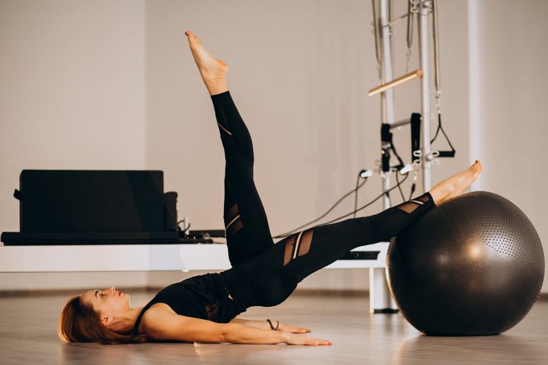 Woman doing pilates with a ball