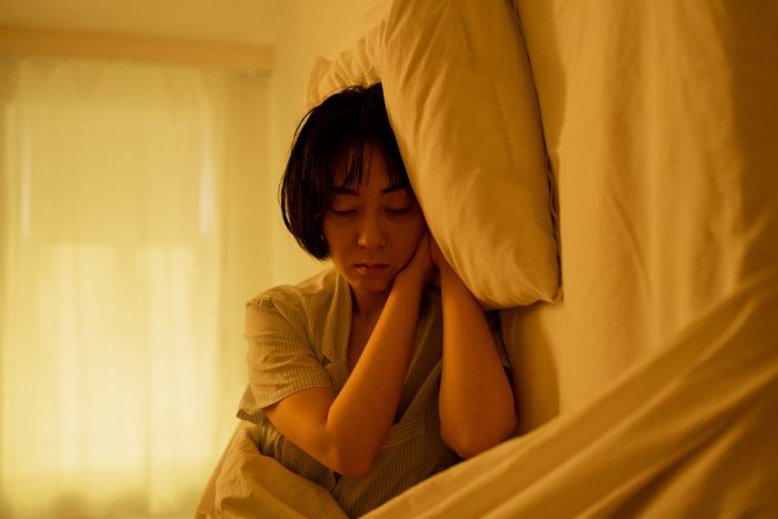 A Tired Woman Sleeping on the Bed