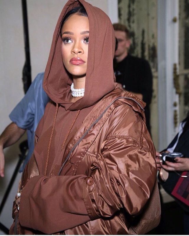 Rihanna in a brown hoodie