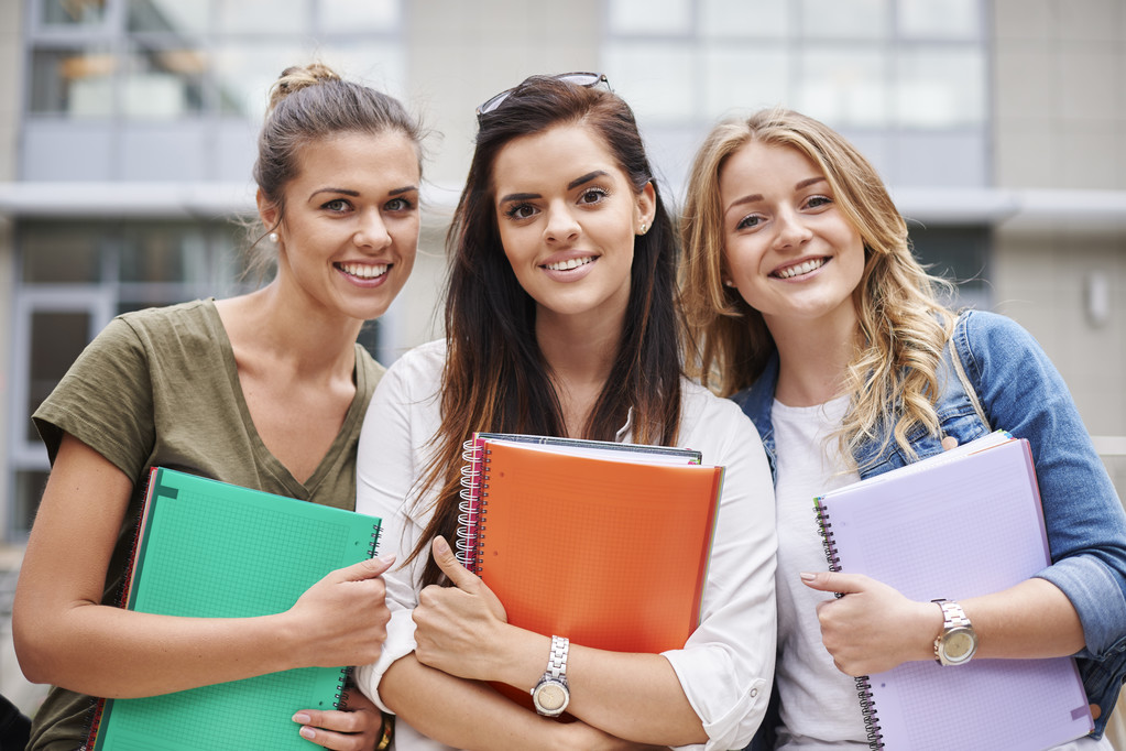  female students with notebooks in campus