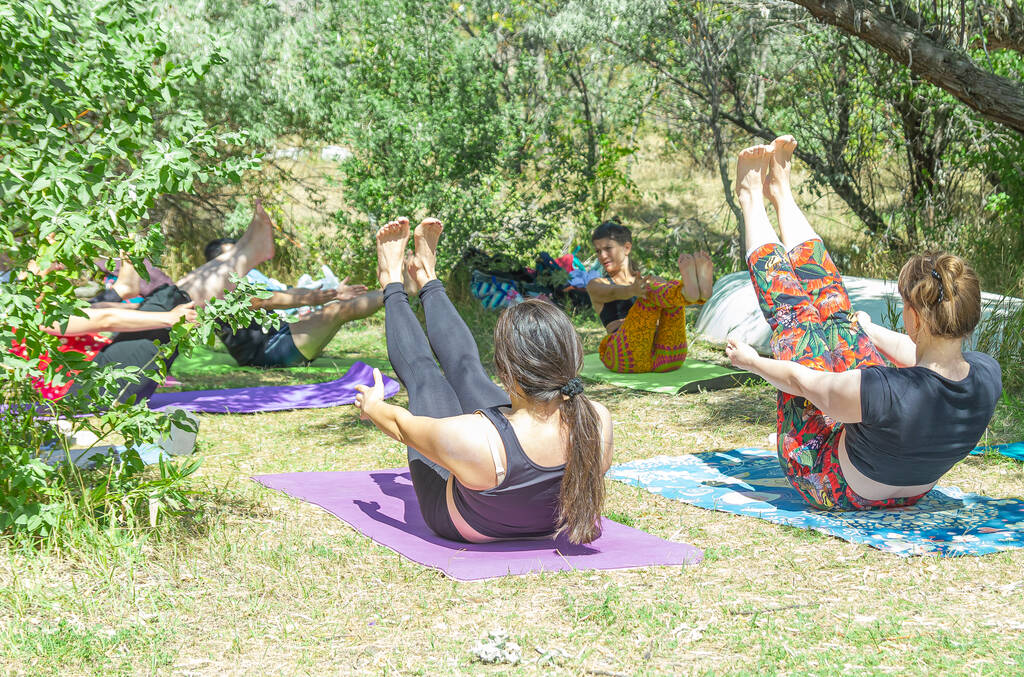 Group of people doing yoga exercise in the park