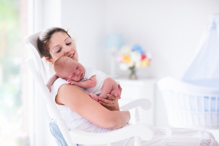 Young mother holding her newborn child.