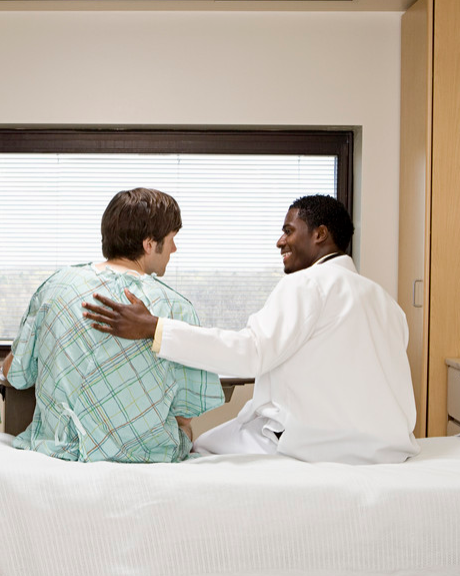 Doctor reassuring patient in hospital