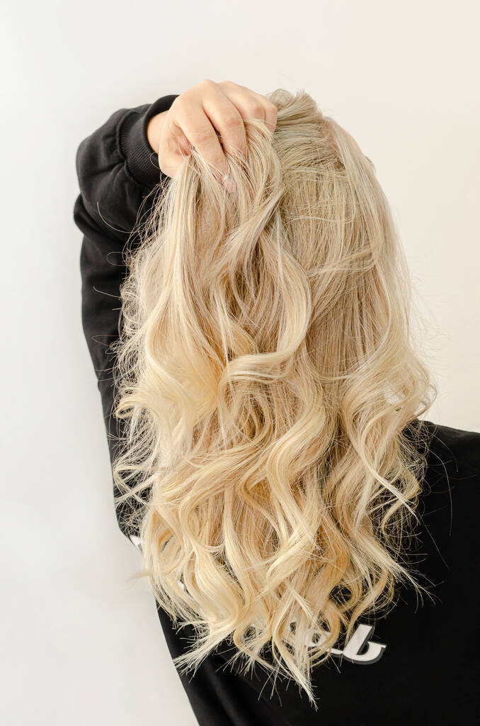 Close up of woman hands hold comb with a lot of hair. Hair loss and unhealthy hair concept.