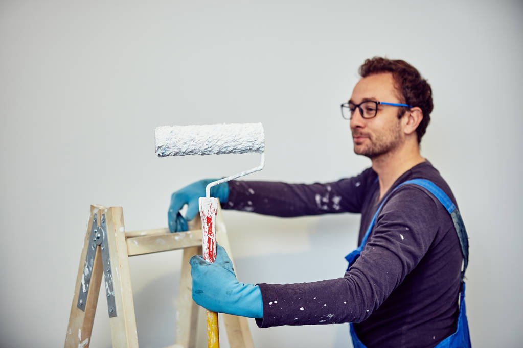 Worker painting walls