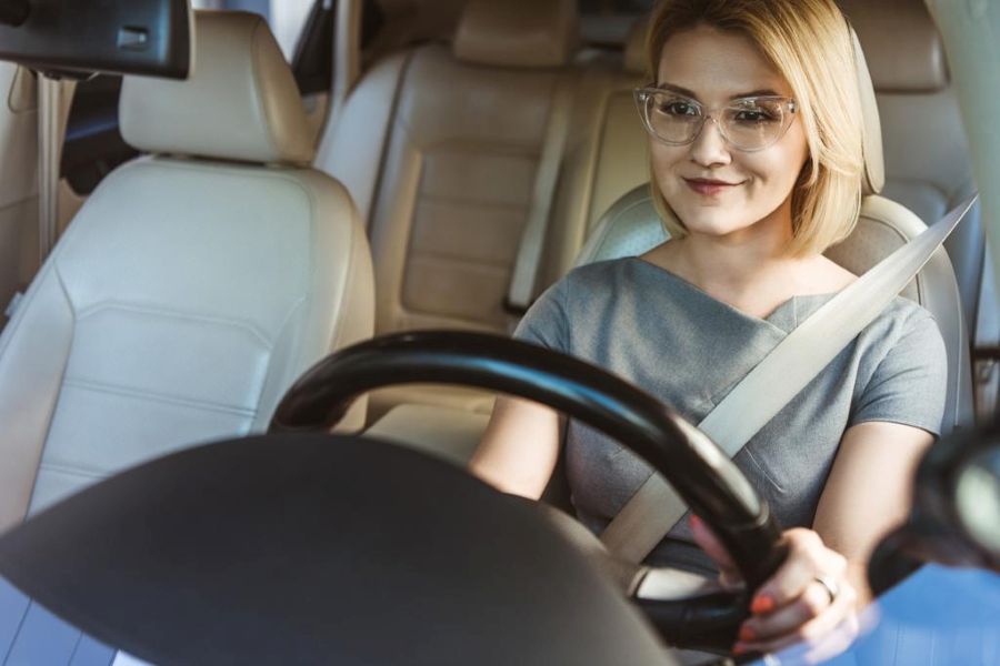 smiling businesswoman driving car