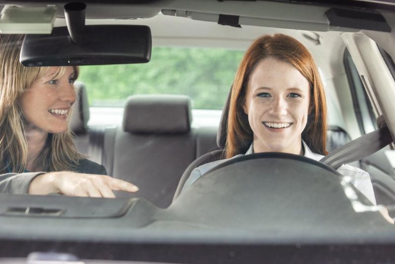 Teenager in car with driving instructor