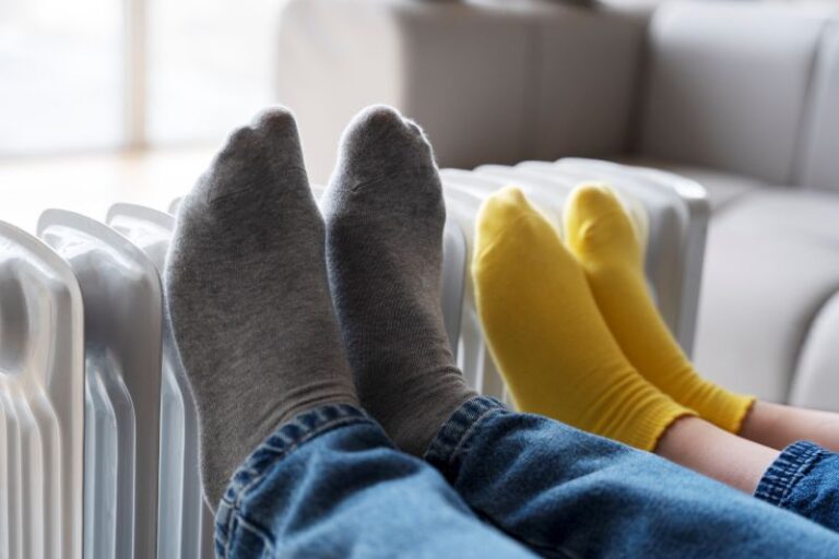 close up people s legs warming up heater
