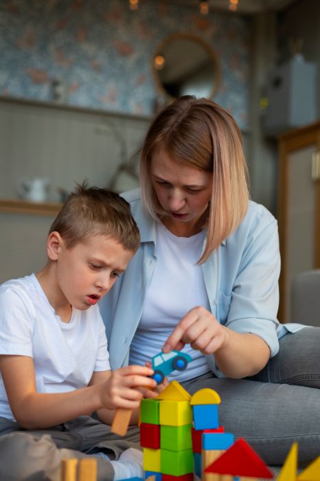 mother playing with her autistic son using toys Autistic