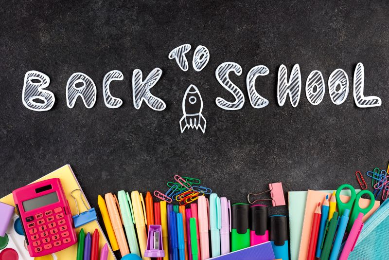 Simple Ways to Best Prepare Your Child for a Return to School back to school background with school supplies chalkboard
