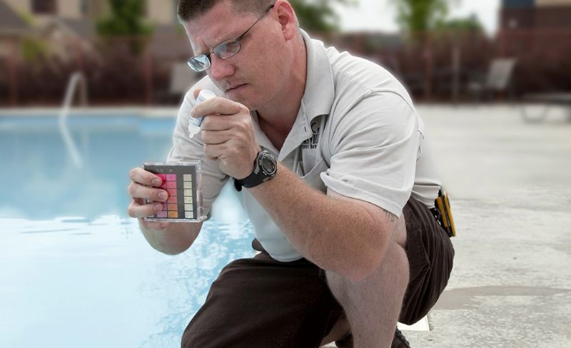 pool water testing guy testing pool water