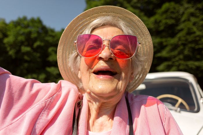 senior woman traveling alone having fun How to Protect Mature Skin From Sun Damage