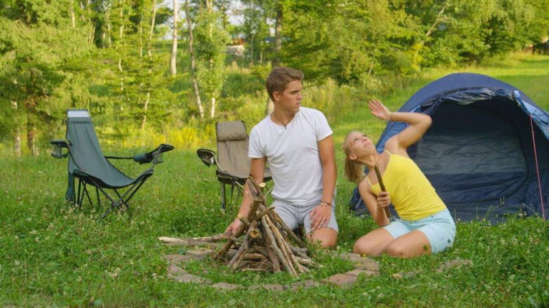 stock photo man and woman on fun camping trip trying to swat the bugs flying around them Insect Protection Kit