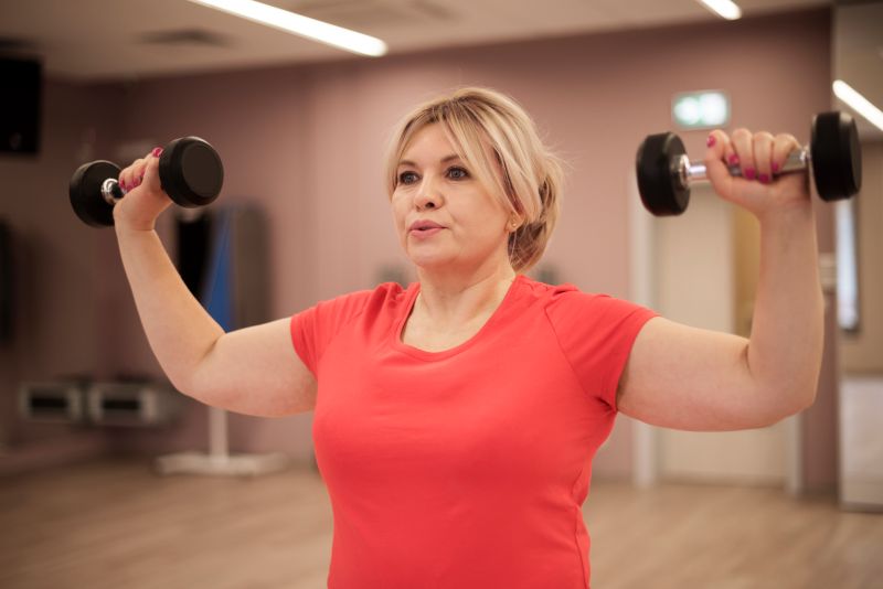 woman training with dumbbells Strength Training After 50: Build Muscle & Strength