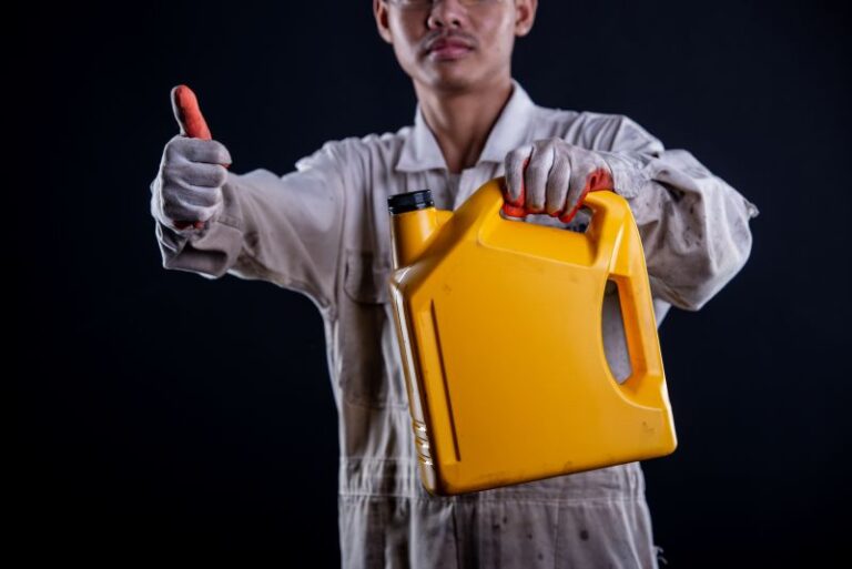 car mechanic wearing white uniform stand holding wrench