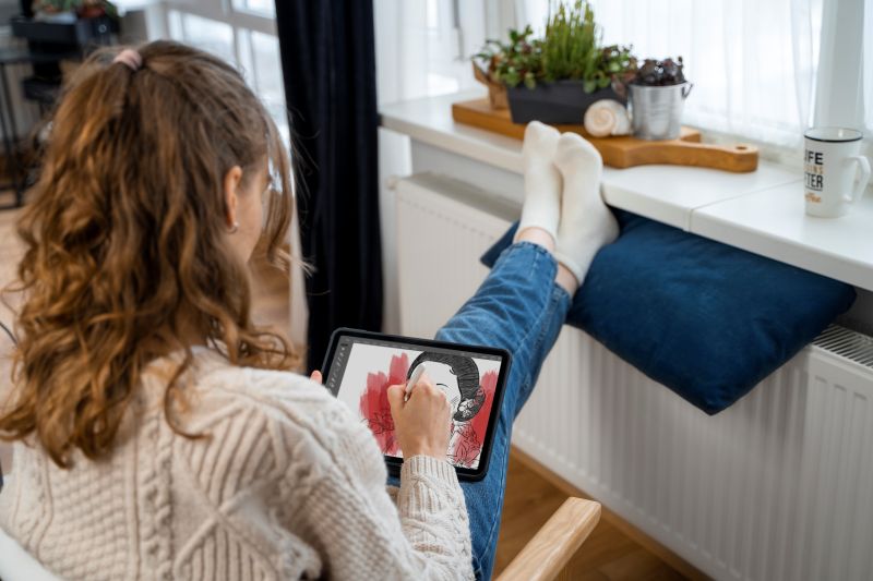 medium shot woman sitting near heater How to Balance Temperatures Between Rooms